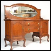 A 1920's oak mirror back sideboard. Raised on cabriole legs with pad feet supporting a bow fronted