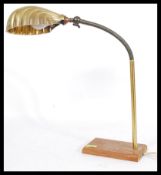 An early 20th century Industrial anglepoise brass lamp with goose neck adjustable neck, cast iron