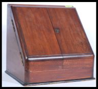 A Victorian mahogany desk tidy with twin doors opening to reveal a stationary sectional interior.