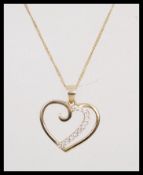 A hallmarked 9ct gold necklace and pendant having a fine curb link chain with bolt ring clasp. The