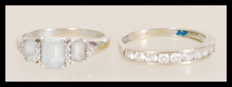 Two stamped 9ct white gold rings to include a ring channel set with round white stones (size R.5),