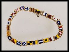 An Edwardian 15ct gold nautical alphabet flag and numerical pennant link bracelet, having 26 links