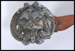 A vintage early 20th century leather belt having a