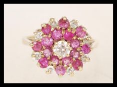 A hallmarked 9ct gold cluster ring set with red and white stones. Hallmarked Birmingham 1989. Weight