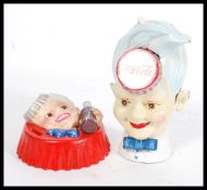 Two 20th century reproduction cast iron money boxes / banks  - each with notation for Coca Cola, and