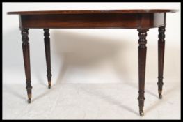 A 19th century George III mahogany d-end demi-lune console table being raised on turned legs with