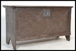 An 18th century carved oak coffer chest / blanket box. The coffer with inverted carved stile
