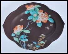 A 19th Century Chinese porcelain tray plate of scalloped form having a brown ground with hand