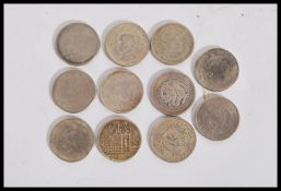 A group of 11 Chinese silver coins featuring dragon coins, various leaders and character marks.