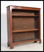 An Edwardian solid mahogany open window bookcase cabinet being raised on bracket feet with 3 shelves