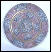 A 19th century Indian brass charger of circular form having silver and copper overlay decoration