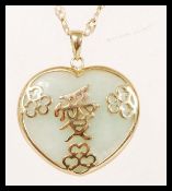 A hallmarked 9ct gold Chinese pendant necklace with a jade pendant to the bottom with gold character