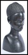 An early 20th Century African hardwood ebony carved bust, the bust carved in great detail of a young