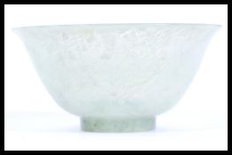 A 19th Century Chinese jade tea cup bowl of conical form having a mottled green jade colourway.
