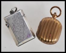 A silver hallmarked vesta case of rectangular sarcophagus form having engraved floral design along