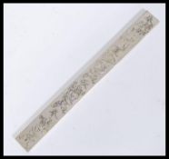A 20th Century Chinese silver white metal scroll weight plaque of elongated rectangular form