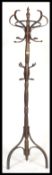 A vintage 20th century Thonet style bentwood hat stand being raised on splayed legs with s-shaped