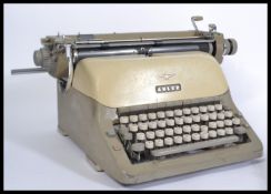 A vintage mid 20th Century retro industrial typewriter by Adler stamped for West Germany. Along with