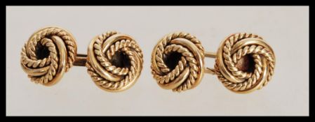 A pair of hallmarked 9ct gold gents cufflinks ( cufflink cuffs ) of rope twist knot form. Weighs