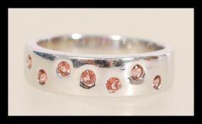 A hallmarked 9ct white gold ring set with small brown stones. Hallmarked Birmingham. Weight 4.1g.