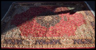 A Persian Islamic Keshan carpet having a red groun