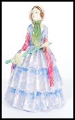 An early Royal Doulton ceramic figurine entitled Rita HN1450. Stamped to base. Measures 18cm high.
