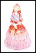 A Royal Doulton ceramic figurine entitled Lady Clare HN1465. Stamped to base. Measures 20cm high.