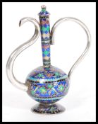 A 20th Century silver ornamental Cloisonne teapot raised on a round foot with a bulbous body and
