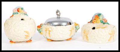 A collection of early 20th century Clarice Cliff ' Celtic Harvest ware ' condiment pots / lidded