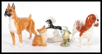 A selection of china animal figurines to include a Royal Doulton Boxer dog figurine marked Warlord