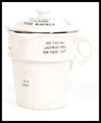 A ceramic vintage 20th century Clarke's Pyramid food warmer of white glaze with black notation being