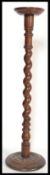 A good Victorian 19th century mahogany torchere plant stand of tall form raised a barley twist