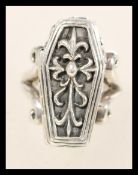 A sterling silver ring in the form of a coffin having a hinged door revealing a spooky