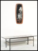 A vintage retro 20th century low coffee table raised on a metal frame with retro print top