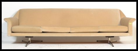 A Danish 1960's vintage retro sofa settee upholstered in cream velour raised on metal splayed