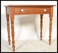 A 19th century Victorian pitch pine writing table desk being raised on turned legs with single