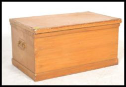 A 19th Century Victorian pine blanket box, hinged top with clasp to front, carry handles to side