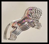 A sterling silver brooch in the form of four leaping horses. Stamped sterling. Weighs 9.2 grams.