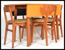 A stunning vintage 20th Century circa 1960's dining suite, consisting of a orange laminated topped