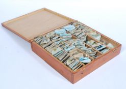 A selection of vintage 20th Century perspex watch glasses within a wooden case all in paper
