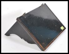 A Victorian ebonised mahogany clock bracket shelf being raised on scroll supports with carved