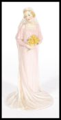 A Royal Doulton ceramic figurine HN1600 'The Bride designed by Arthur Leslie Harradine. Stamped to