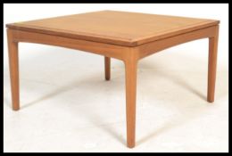 A vintage retro 20th Century teak wood coffee table by Legate raised on square tapering legs. Makers