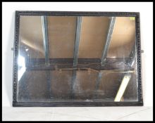 A large 19th century Victorian  shop mirror having a cushion frame with gadrooned inner border.