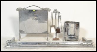 A 1930's Art Deco chrome fireside suite comprising fire fenderkerb, coal bucket,  fire screen and