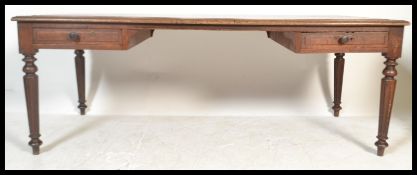 A very large 19th Century solid oak French library table / desk being  raised on turned column