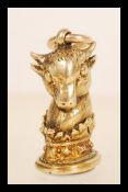 A 9ct gold fob pendant charm in the form of a bull within a crown having a blank seal to base.