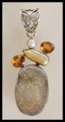 A stamped 925 silver pendant set with a citrines, pearls and a grey crystal stone. Weight 22.8g.