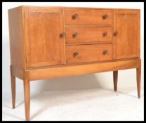 A mid century Cotswold School walnut sideboard Credenza by Arthur Reynolds, Ludlow having tapering