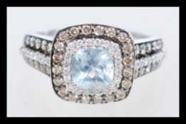 A hallmarked 14ct white gold, diamond and aquamarine ring, branded Le Vian, set with a cushion cut